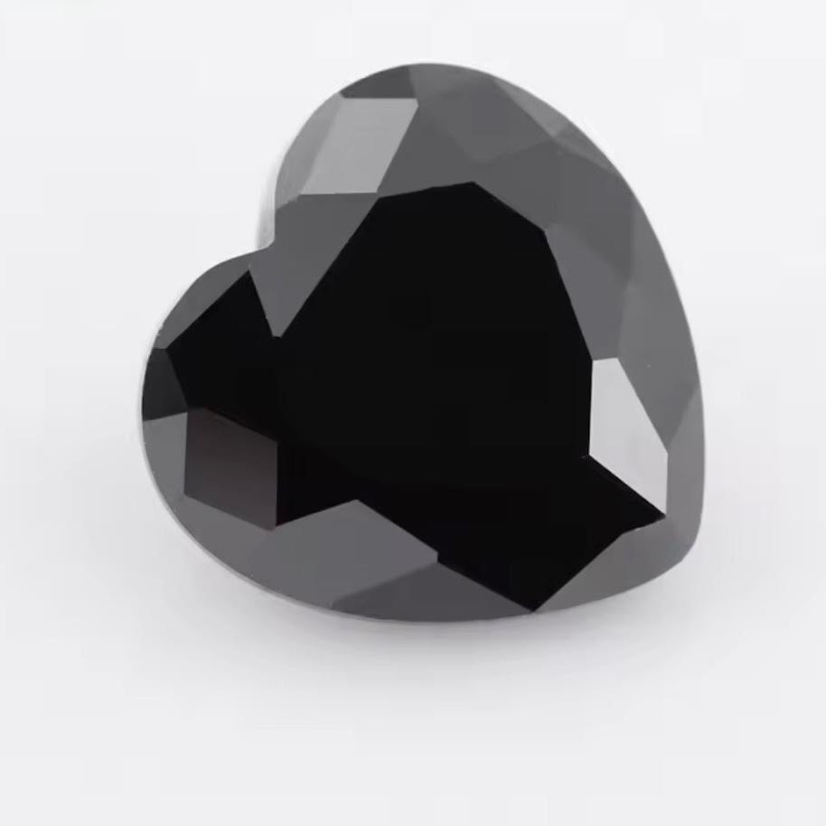 Heart-shaped black gemstone on a white background