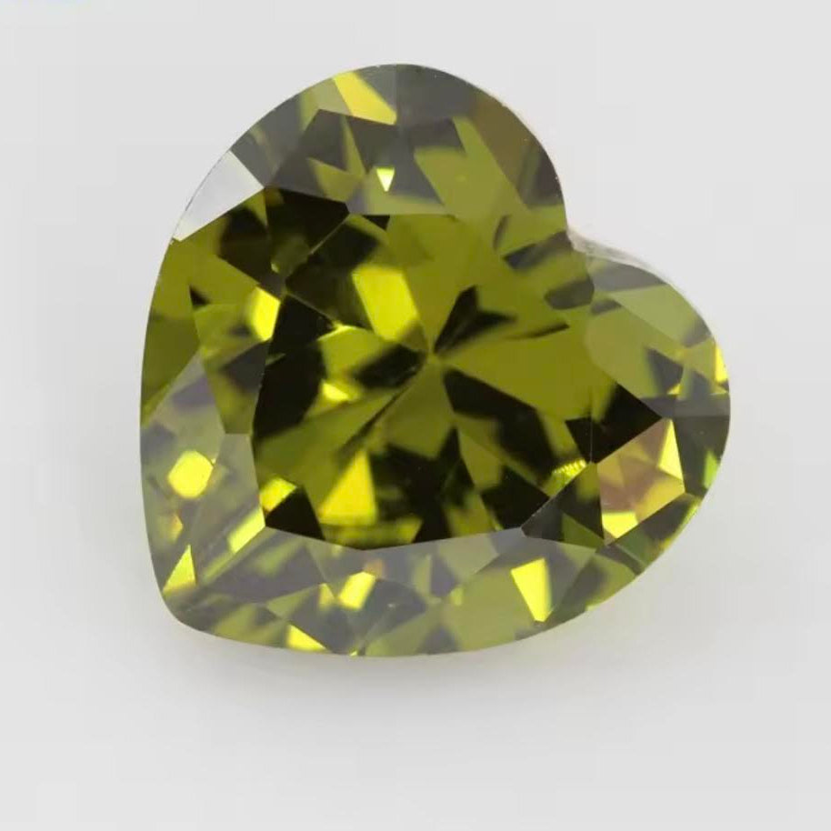 Heart-shaped green gemstone on a white background