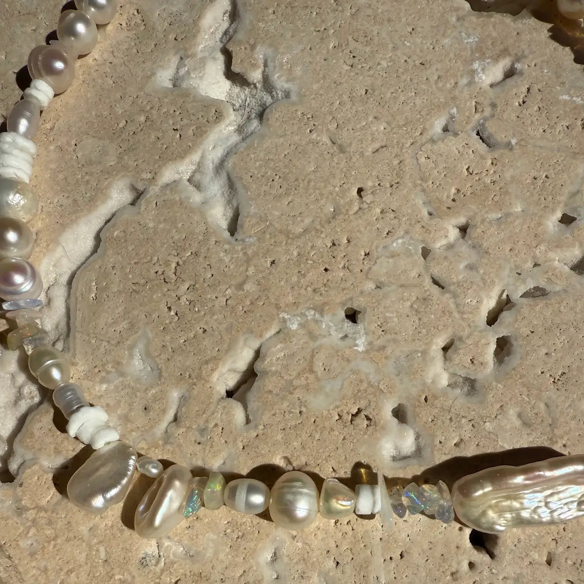 Beaded necklace on a textured stone surface