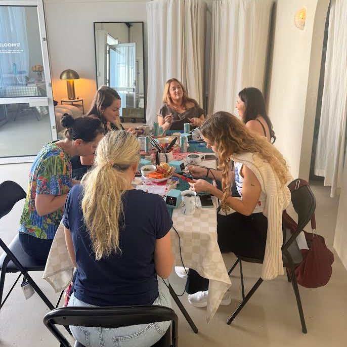 Group of women sitting around a table in a modern indoor setting