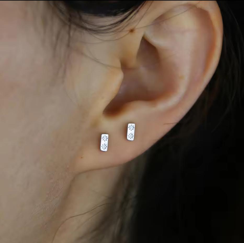silver studs in close up of ear
