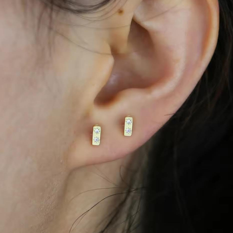 newest gold studs in a close up of ear
